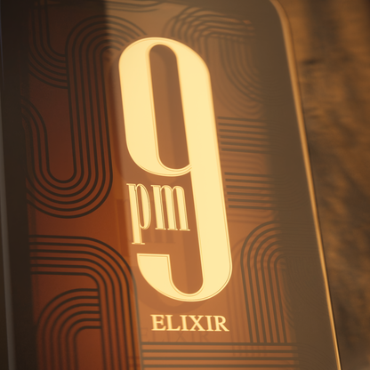 Close-up of a bottle labeled '9 pm Elixir' with a gold number '9' on a dark background.